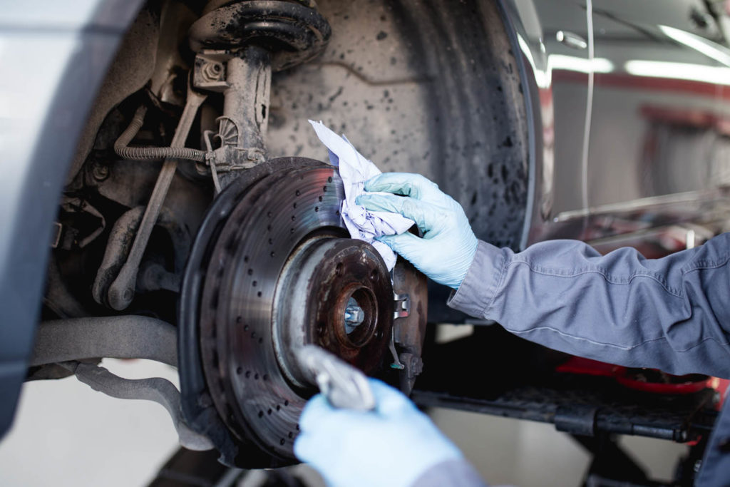 mechanic cleaning brake discs